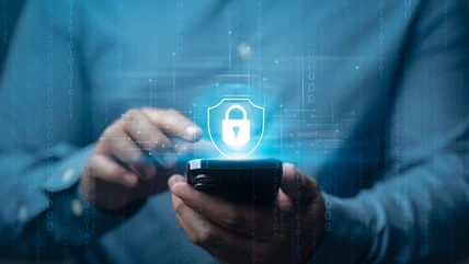 Man holding a smartphone with a lock icon floating above it.