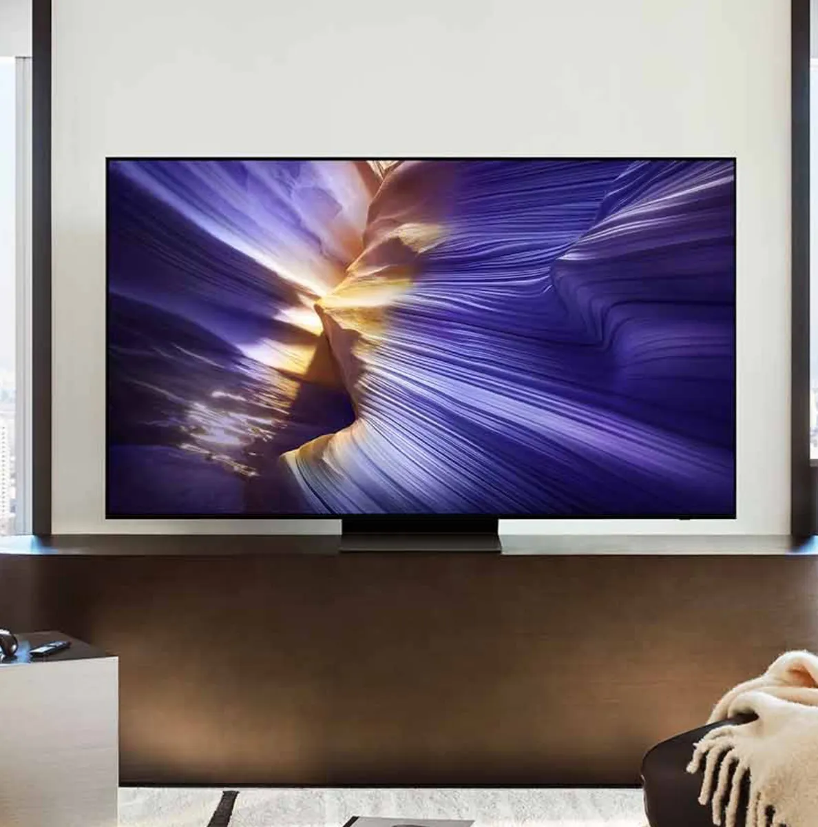 Samsung’s Frame Pro TV wall mounted above a fireplace with a soundbar.