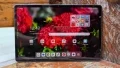 Lenovo Idea Tab Plus being held with left hand at library
